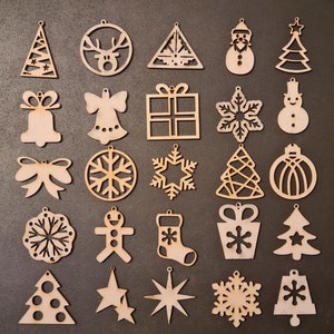 25 laser cut wooden Christmas ornaments. Original Christmas decoration, to place on a table or to hang. Winter atmosphere.