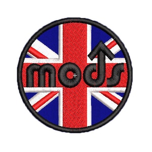 May include: A round black and white patch with a red cross and the text "mods" in black letters. The patch has an upward pointing arrow in the center.