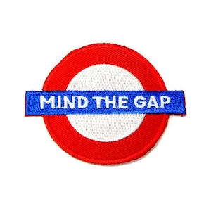 May include: Red and white London Underground circle with the text "MIND THE GAP" in blue on a blue and white stripe.