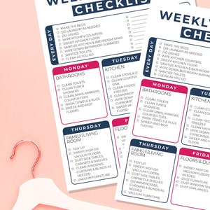 May include: Weekly cleaning checklist with daily and weekly tasks. The checklist includes tasks for bathrooms, kitchen, family/living room, and floors. The checklist is on a white paper with a pink background and a white hanger.