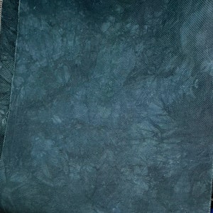 May include: A dark gray fabric with a textured surface. The fabric has a subtle pattern of light gray spots.