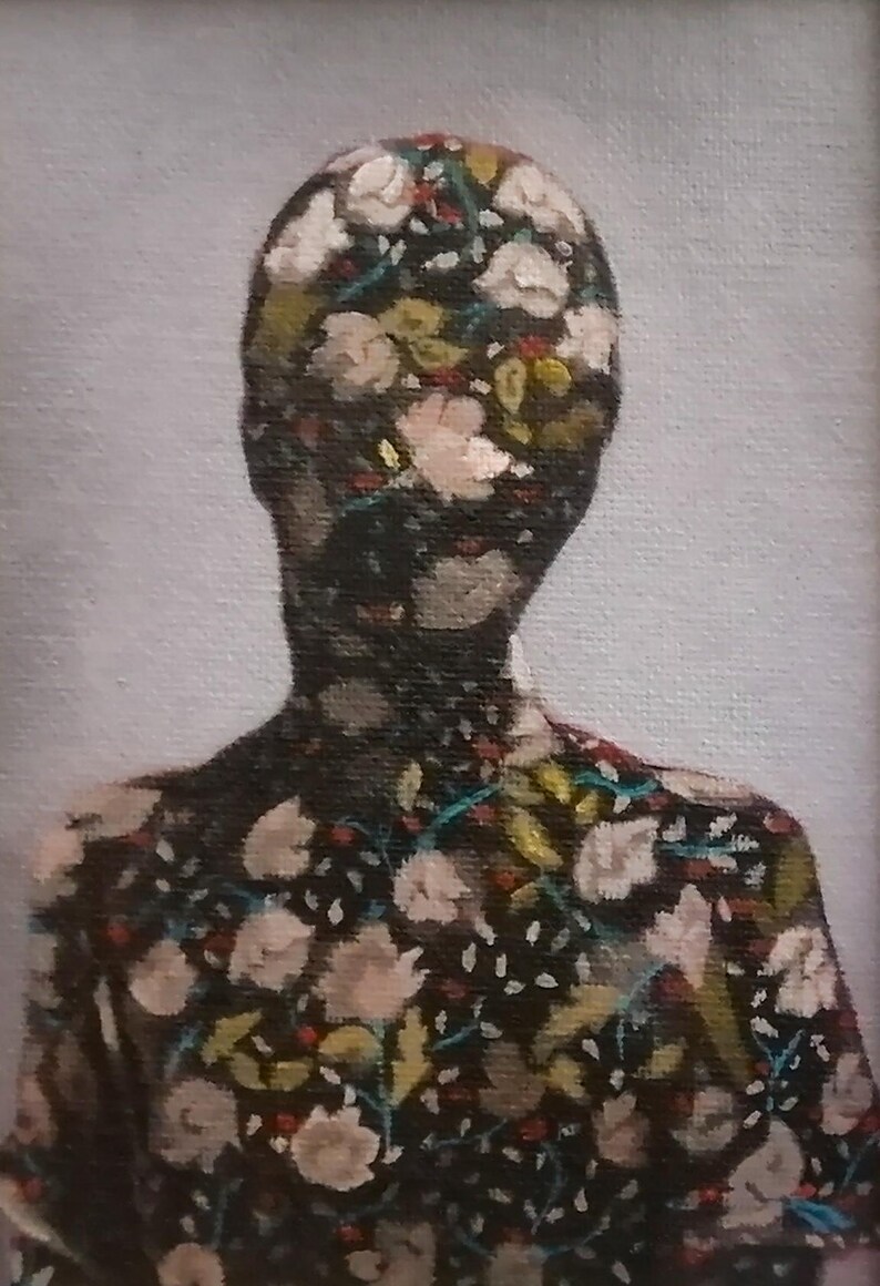 May include: An oil painting of a person's silhouette, their form filled with a floral pattern. The flowers are white, pink, and yellow against a dark background. The artwork is set against a light gray backdrop.