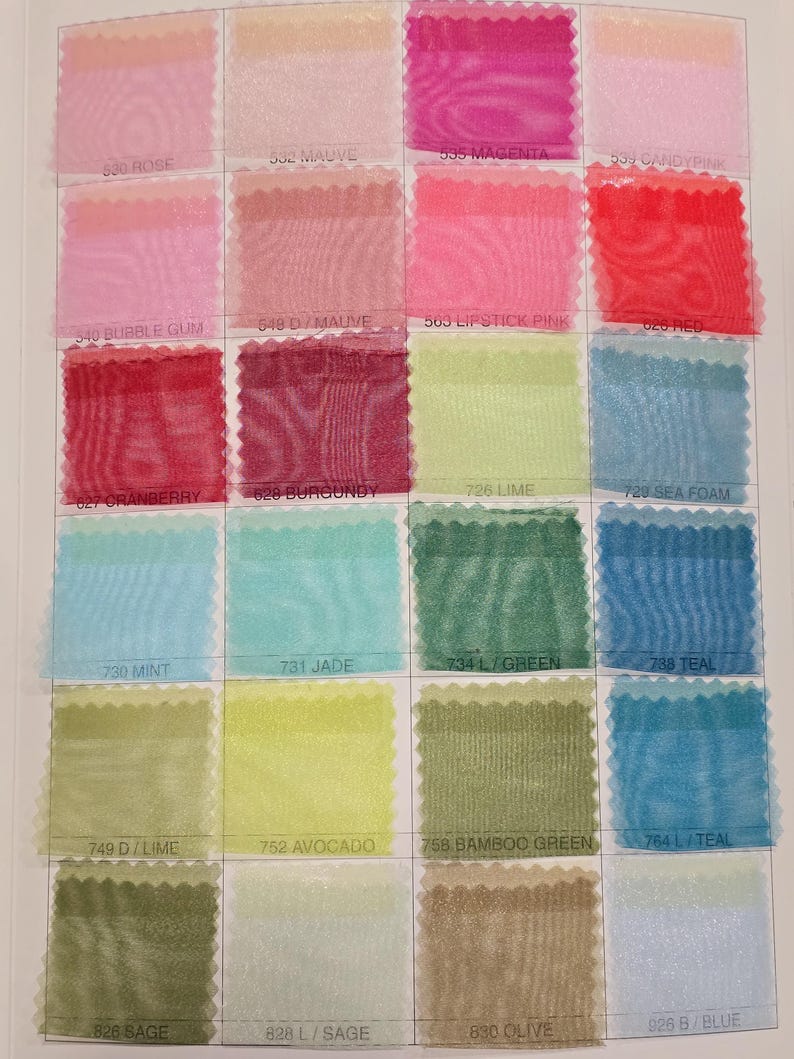 May include: A color chart of sheer fabric swatches in various shades of pink, red, green, blue, and yellow. The swatches are labeled with numbers and color names.