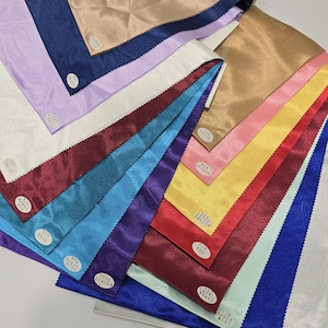 May include: A collection of 14 different colored satin ribbon samples. The colors include silver, royal blue, mint green, red, yellow, coral, gold, white, lavender, navy blue, teal, burgundy, purple, and brown.