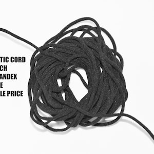 May include: A close-up of a black 3mm elastic cord, made of nylon spandex. The cord is soft to the touch and latex free. The text "JET BLACK", "3MM ELASTIC CORD", "*SOFT TOUCH", "*NYLON SPANDEX", "*LATEX FREE", and "*WHOLESALE PRICE" is visible in the image.