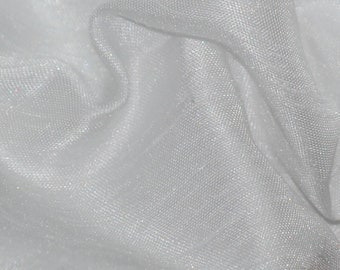 May include: White sheer fabric with a subtle shimmer. The fabric is wrinkled and has a soft, delicate texture.