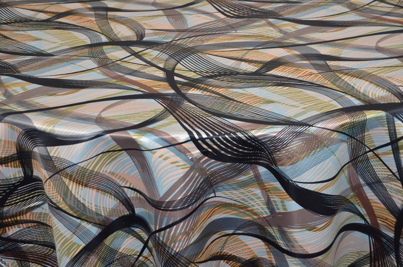May include: Abstract patterned fabric with black, brown, blue, and orange wavy lines on a white background.