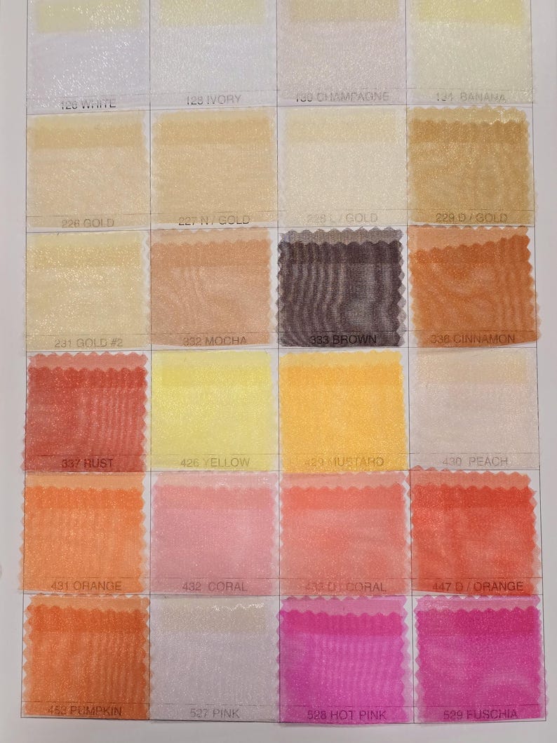 May include: A color chart of sheer fabric swatches in various shades of white, yellow, orange, pink, and red. The swatches are labeled with numbers and color names, such as "White", "Ivory", "Champagne", "Banana", "Gold", "Mocha", "Brown", "Cinnamon", "Rust", "Yellow", "Mustard", "Peach", "Orange", "Coral", "D/Orange", "Pumpkin", "Pink", "Hot Pink", and "Fuschia".