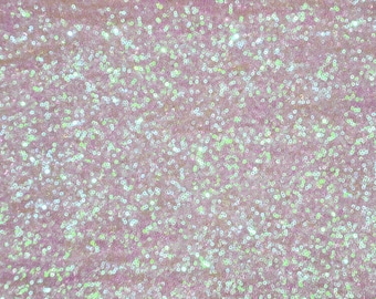 May include: A close-up of iridescent pink fabric with a sparkly, sequin texture.