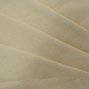 May include: Close-up of a folded piece of natural-colored canvas fabric. The fabric has a smooth, even texture and a subtle sheen.