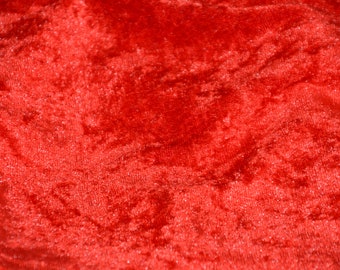 May include: Close-up of a red velvet fabric with a soft, plush texture.