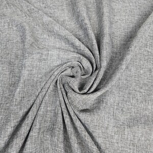 May include: Close-up of a gray fabric with a textured weave. The fabric is draped and folded, creating shadows and highlights that emphasize its texture. The material appears to be a medium-weight fabric, suitable for various sewing projects.