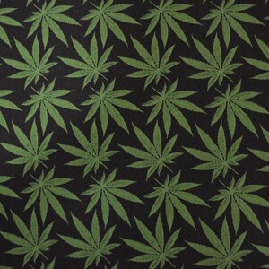 May include: Black fabric with a repeating pattern of green cannabis leaves.