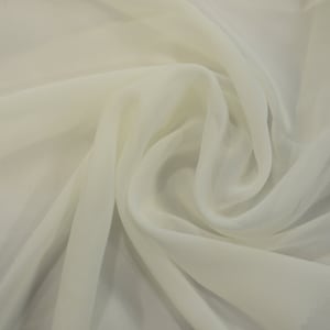 May include: A piece of white sheer fabric, folded and draped, showcasing its soft and delicate texture.