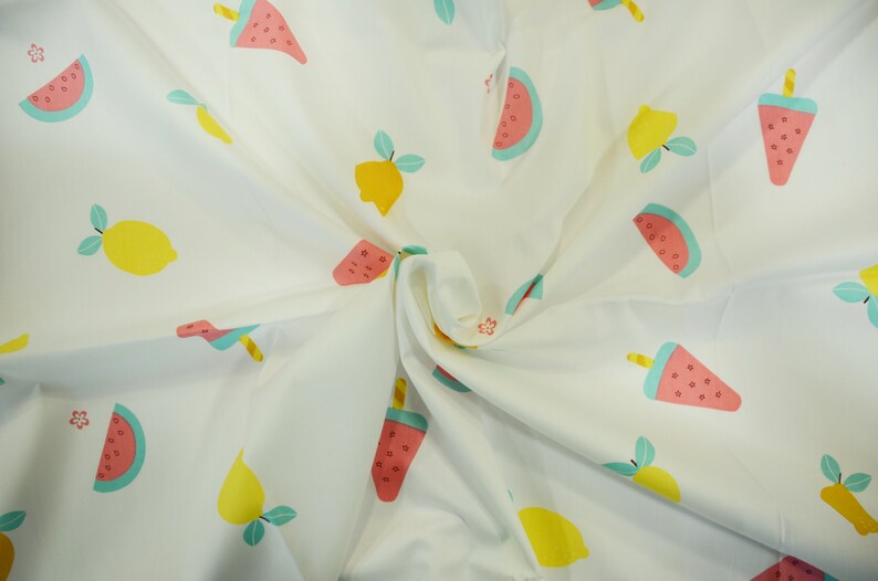 May include: White fabric with a repeating pattern of pink and green watermelon slices and yellow lemons with green leaves.