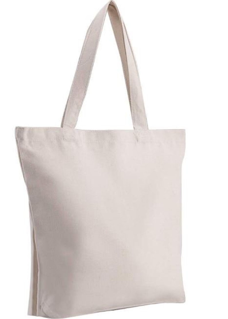 May include: A plain white canvas tote bag with two handles. The bag is made of a sturdy fabric and has a large capacity.