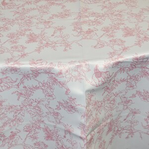 May include: White tablecloth with a pink floral pattern featuring stylised birds and trees.