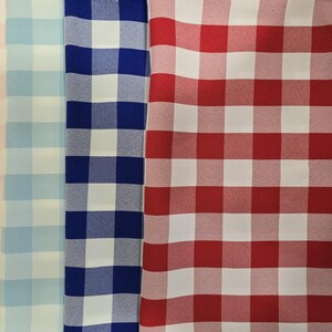 May include: Three fabric swatches with a gingham pattern. The swatches are pink and white, light blue and white, and navy blue and white.