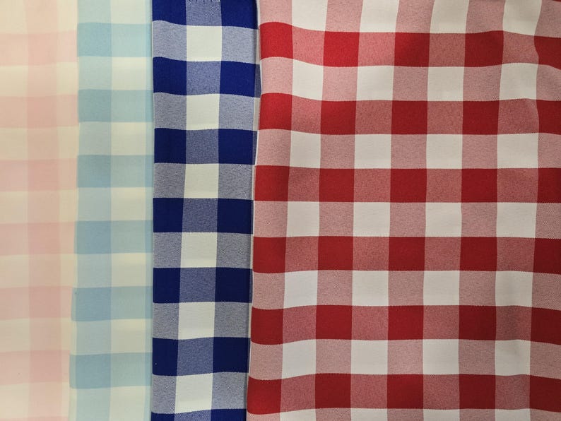May include: Three fabric swatches with a gingham pattern. The swatches are pink and white, light blue and white, and navy blue and white.