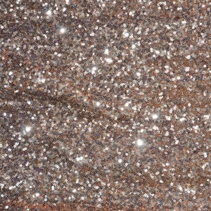 May include: A close-up of a fabric covered in shimmering sequins. The sequins are a mix of silver and rose gold.
