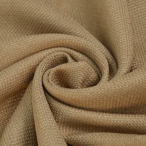 May include: Close-up of a brown woven fabric with a textured surface. The fabric is folded and draped, creating a soft, natural look.
