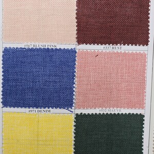 May include: A fabric swatch card featuring six different colored fabric samples. Colors include blush pink, rust, denim, mauve, yellow, and hunter green. Each swatch has a corresponding color code label.