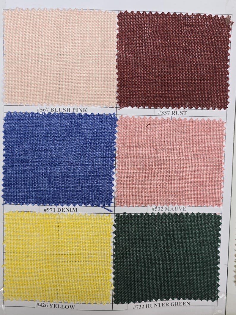 May include: A fabric swatch card featuring six different colored fabric samples. Colors include blush pink, rust, denim, mauve, yellow, and hunter green. Each swatch has a corresponding color code label.