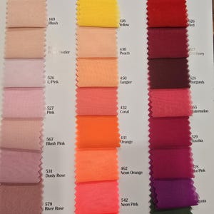 May include: Swatch card with 20 fabric samples in various shades of pink, red, orange, yellow, and green. Each sample is labeled with a number and a color name.