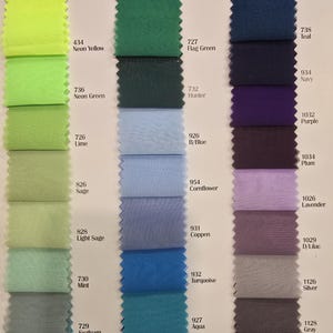 May include: A color chart with fabric swatches in various shades of green, blue, purple, and gray. Each swatch is labeled with a number and a color name.