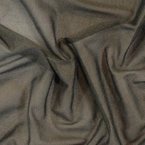 May include: A close-up of a black sheer fabric with a subtle textured pattern. The fabric is draped and folded, creating soft folds and wrinkles.