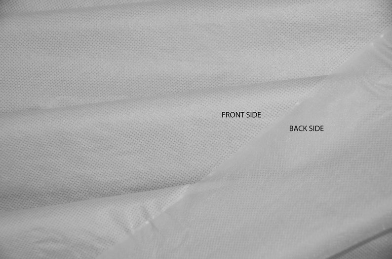 May include: A close-up of a white fabric with a textured surface. The fabric is folded in half, showing the front and back sides. The text "FRONT SIDE" and "BACK SIDE" is printed on the fabric.