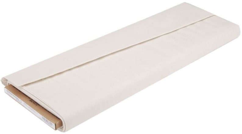May include: A roll of white canvas fabric, folded and partially unrolled, with a brown cardboard tube visible at the bottom.