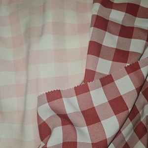 May include: Two pieces of fabric with a checkered pattern. One piece is pink and white, the other is red and white.