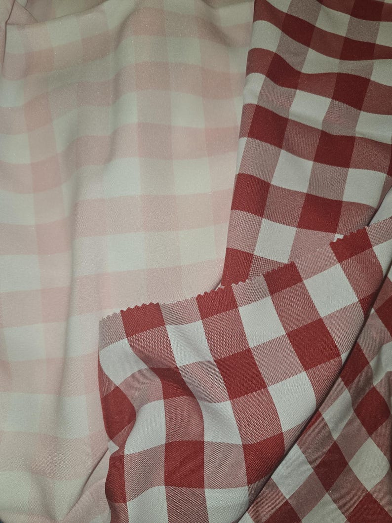 May include: Two pieces of fabric with a checkered pattern. One piece is pink and white, the other is red and white.