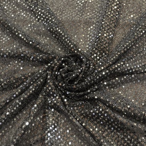 May include: Black fabric with silver sequins in a circular pattern.