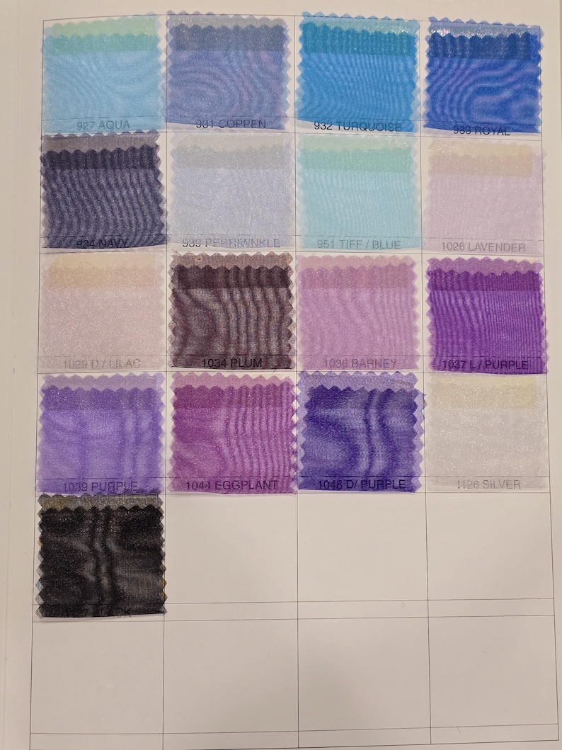 May include: A color chart of sheer fabric swatches in various shades of blue, purple, and silver. The swatches are arranged in a grid with the color names printed below each swatch.
