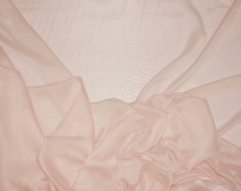 May include: A soft, pale pink sheer fabric with a smooth texture. The fabric is draped and folded, creating a delicate and airy look.