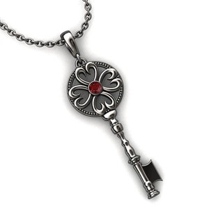 May include: A silver key pendant necklace with a red gemstone in the centre of the key head. The key head is shaped like a flower with five petals.