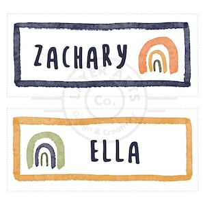 May include: Two watercolor name tags with a rainbow design. The top tag is navy blue with the name "Zachary" and an orange, yellow, and green rainbow. The bottom tag is yellow with the name "Ella" and a green, blue, and orange rainbow.