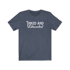 May include: A dark blue t-shirt with the text "INKED AND Educated" in white.