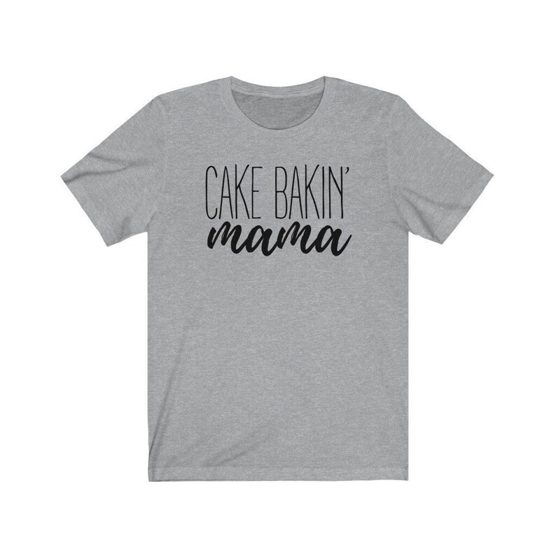 May include: Gray short-sleeved t-shirt with black text that reads "Cake Bakin' mama".