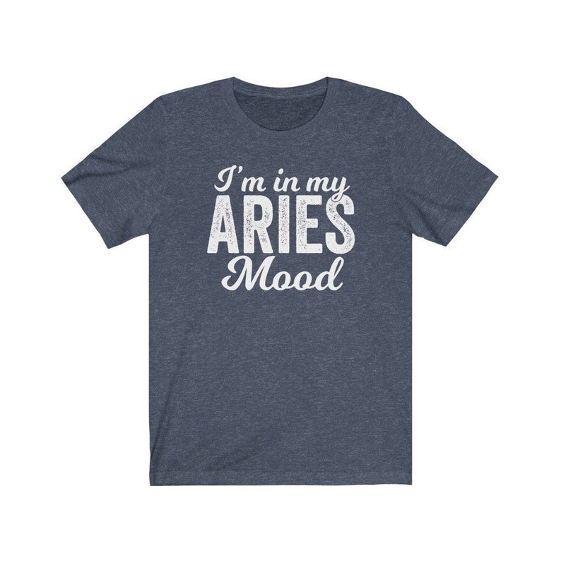 以下が含まれることがあります： 白い文字で「I'm in my ARIES Mood」と書かれた濃い青色のTシャツです。