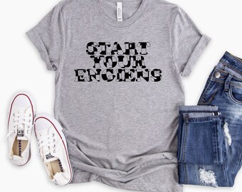 May include: A grey t-shirt with a black and white chequered design that says "START YOUR ENGIENS".