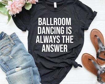 May include: Black t-shirt with white text that reads "Ballroom Dancing is Always the Answer".
