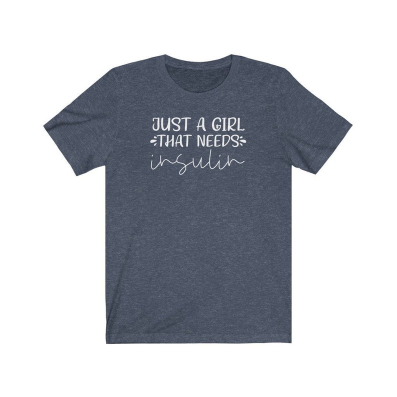 May include: A dark blue t-shirt with the text "Just a girl that needs insulin" in white.
