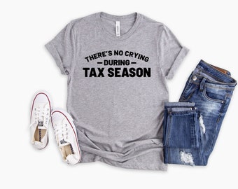 Puede incluir: Camiseta gris con el texto "THERE'S NO CRYING - DURING - TAX SEASON" en negro.