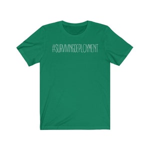 May include: A green short-sleeved t-shirt with the text "#SURVIVINGDEPLOYMENT" printed in white on the front.