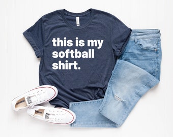 May include: A navy blue t-shirt with white text that reads "this is my softball shirt."
