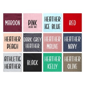 May include: A color chart showing 12 different t-shirt colors. The colors are: maroon, pink (black ink), heather ice blue, red, heather peach, dark grey heather, heather mauve, heather navy, athletic heather, black, heather kelly, and heather olive.