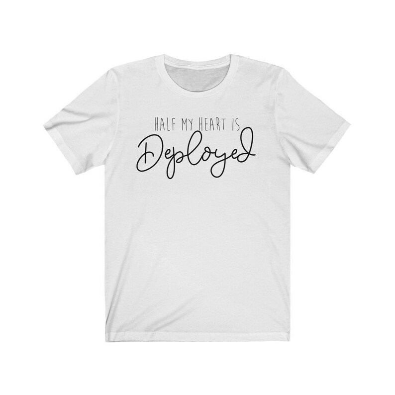 May include: White t-shirt with black text that reads "Half my heart is Deployed".